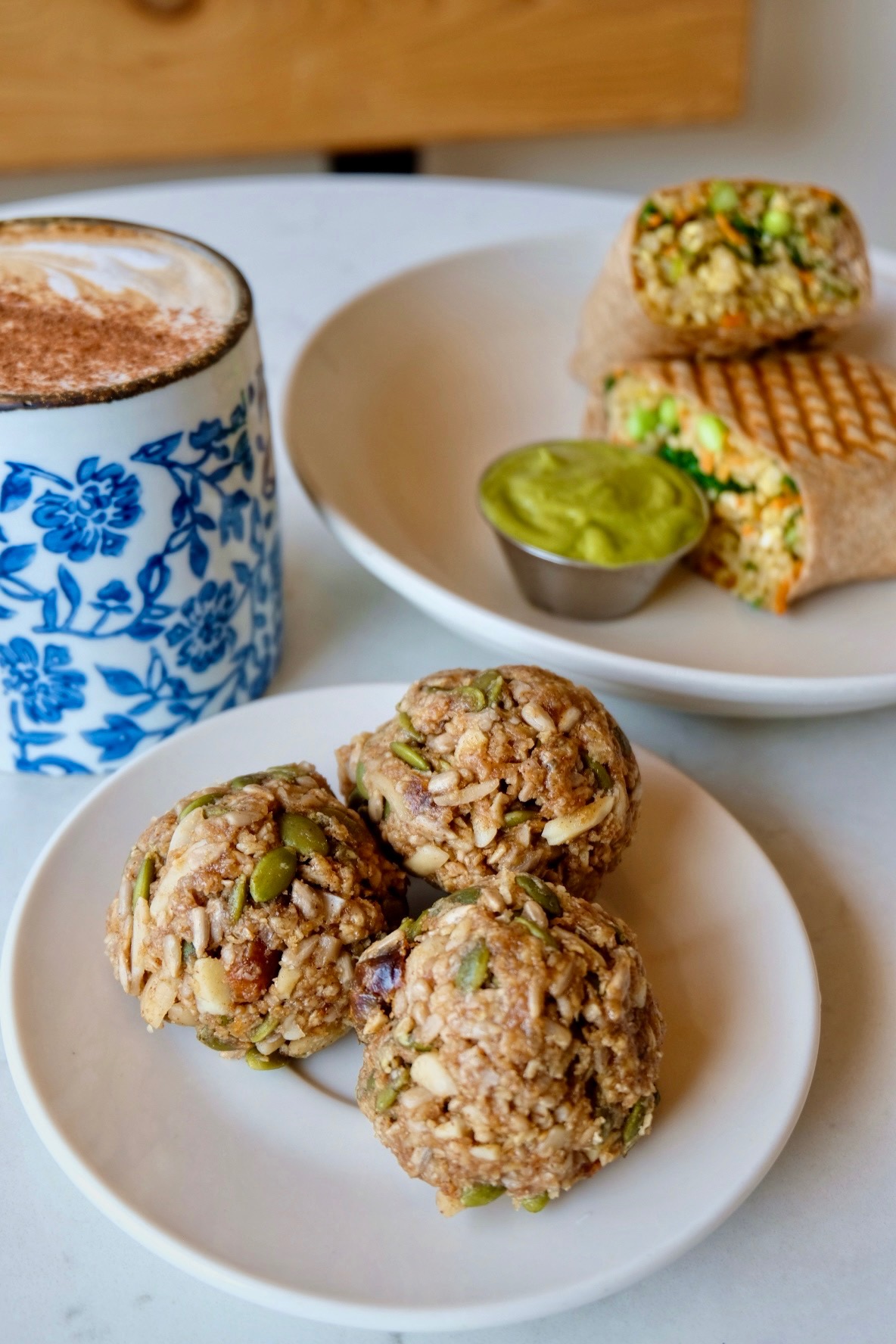 Vegan protein balls, vegan rice wrap, and chai latte with oat milk