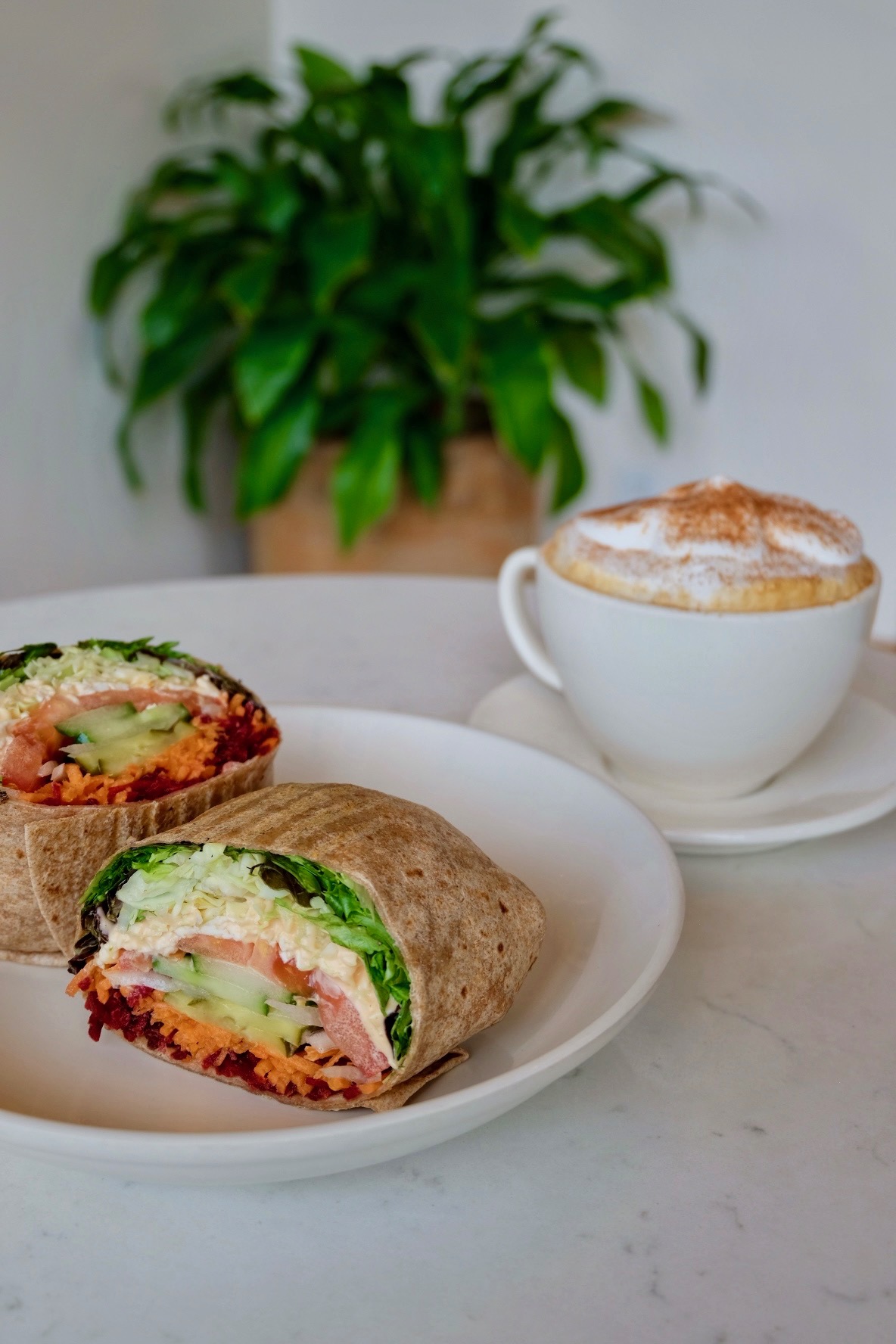 Vegan veggie wrap and cappuccino